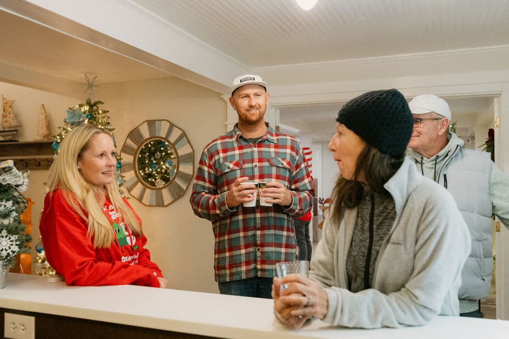 A group of people socializes at a festive gathering.