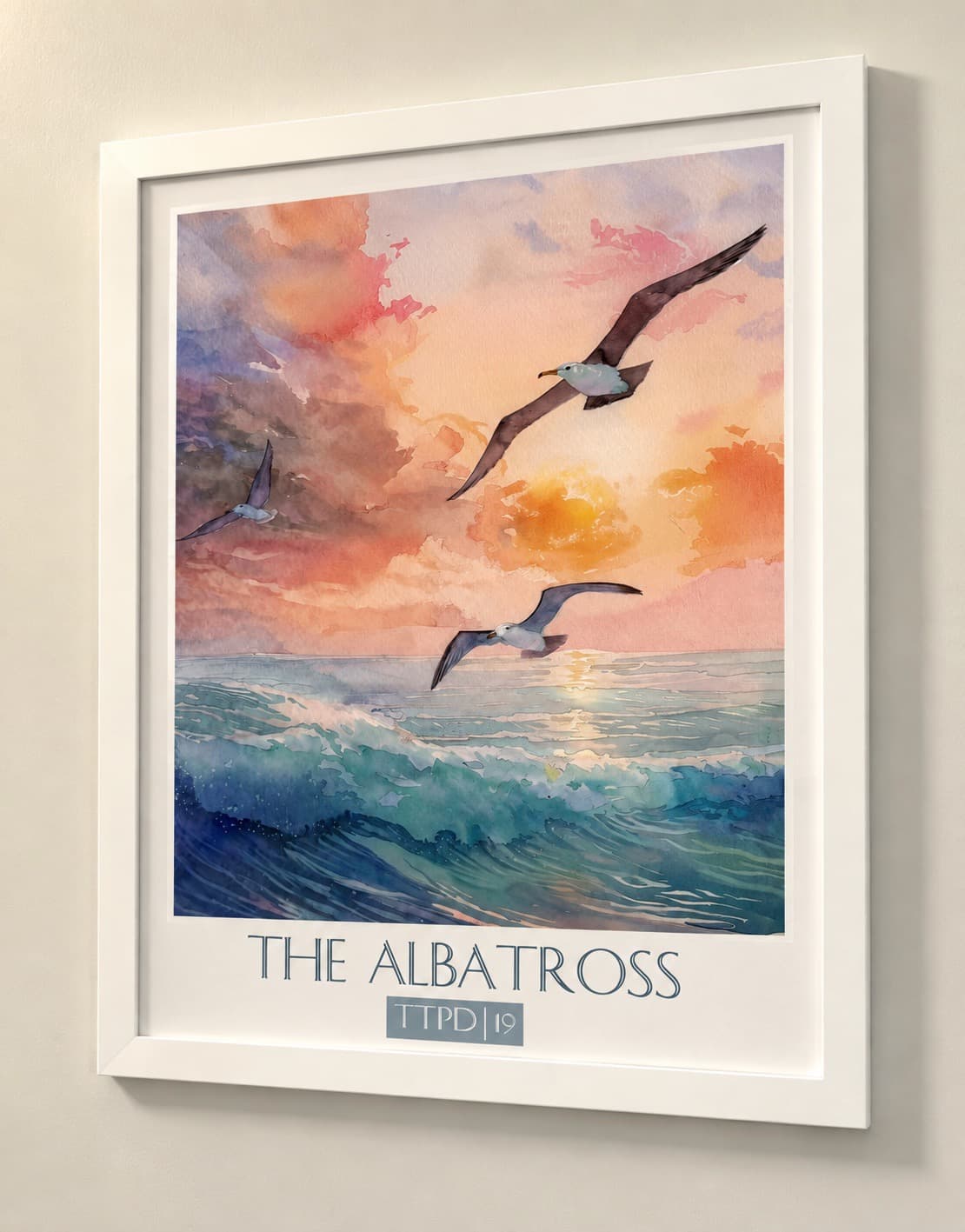 A watercolor painting of seagulls flying over ocean waves at sunset, framed with "THE ALBATROSS" at the bottom.