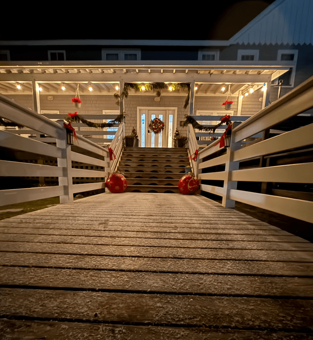 A well-decorated entrance with festive lights and ornaments leads up to a welcoming front door.