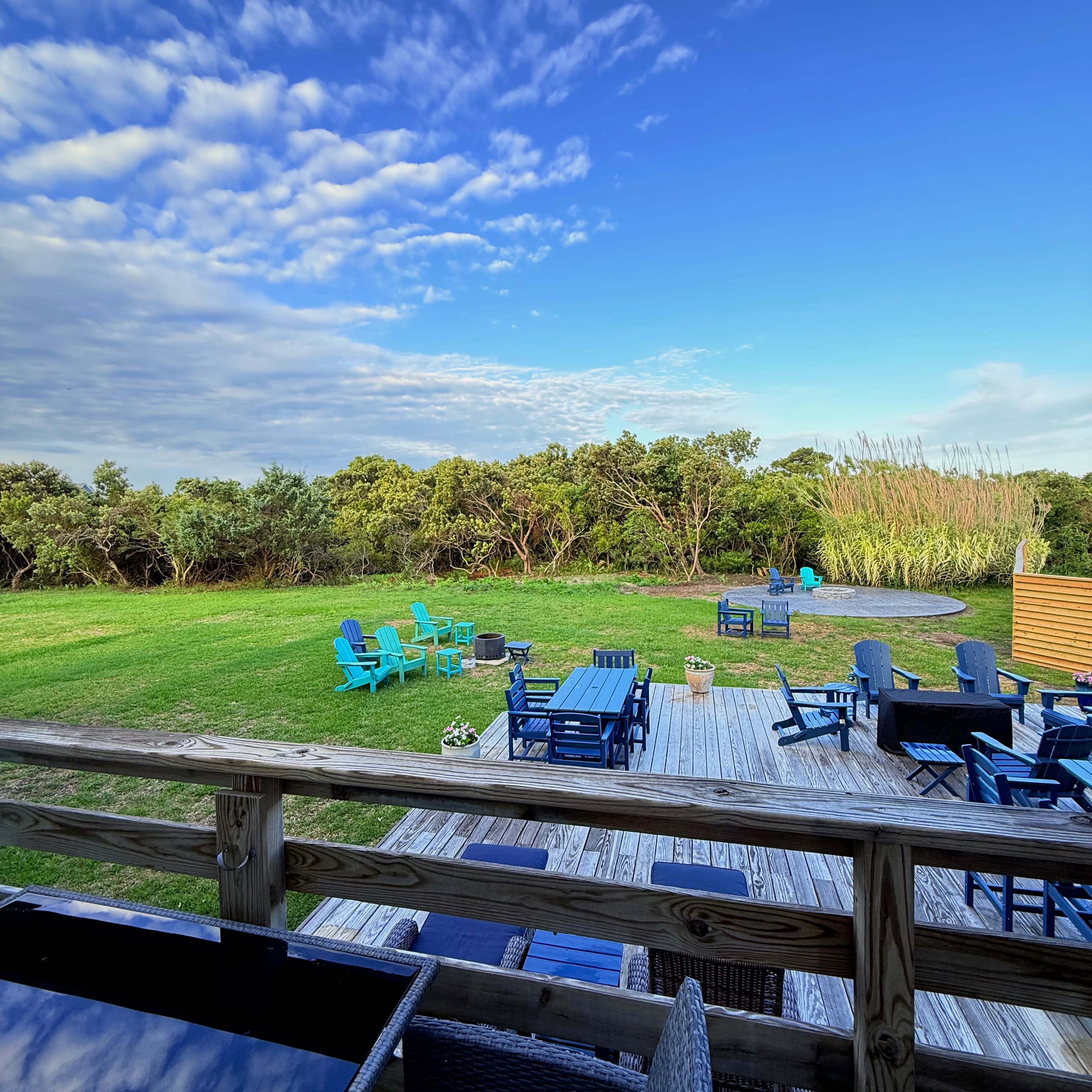 Backyard view from semi-private deck with firepit, trees