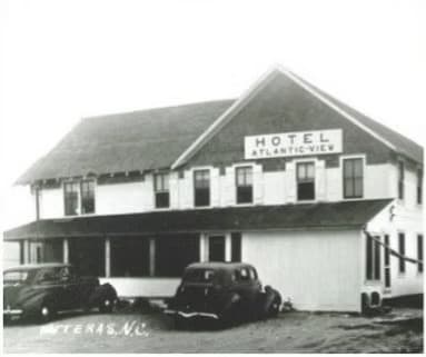 Historical photo of the Atlantic View Hotel in Hatteras, North Carolina, with vintage cars parked out front.